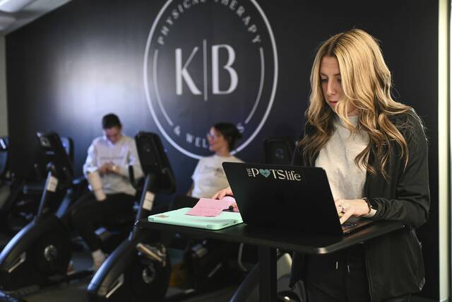 Kelsey Botti (right), a physical therapist, works inside her business, KB Physical Therapy and Wellness, in Trafford.