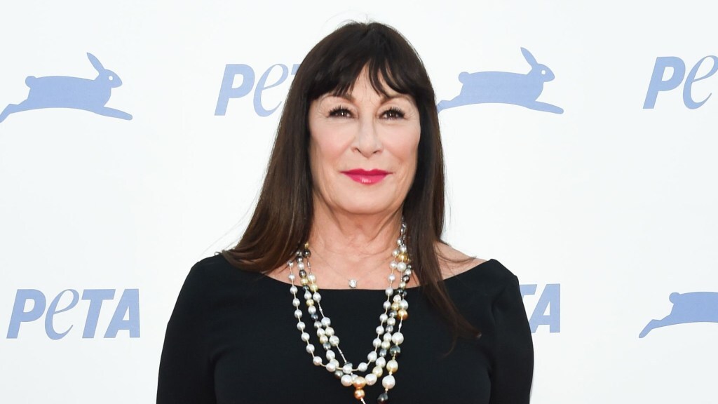 Anjelica Huston poses on a red carpet.