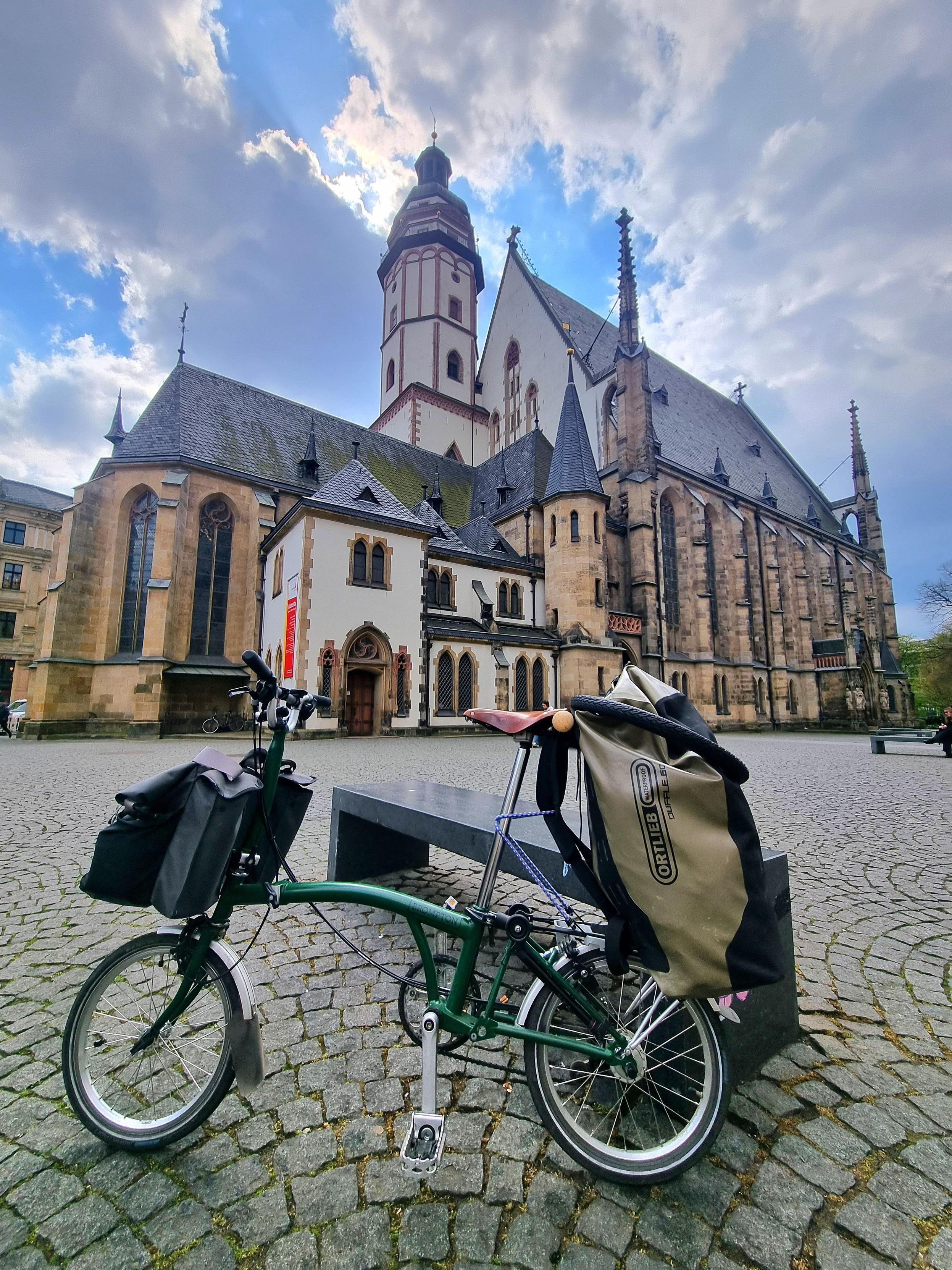 A folding bike in front of the church of St. Thomas in Leipzig, Germany.