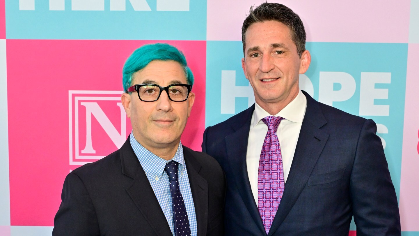Jason Weinberg and husband Merritt Johnson pose together at a Family Equality event.