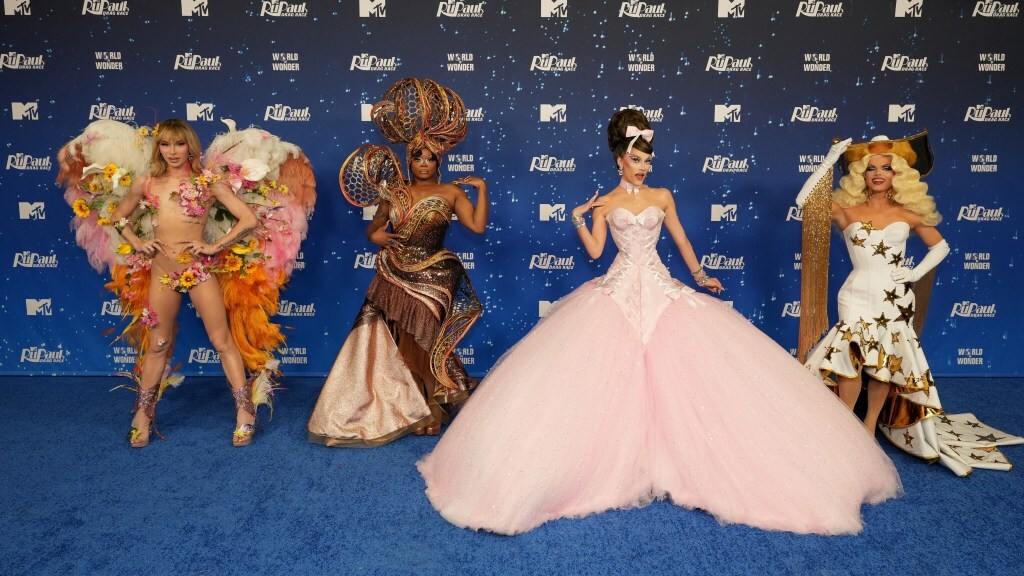 Lexi Love, Onya Nurve, Jewels Sparkles and Sam Star pose in drag on a red carpet.