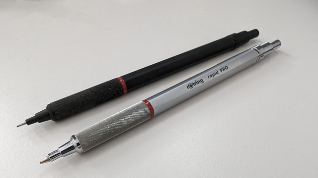 Rotring ball and pencil pen on white table.